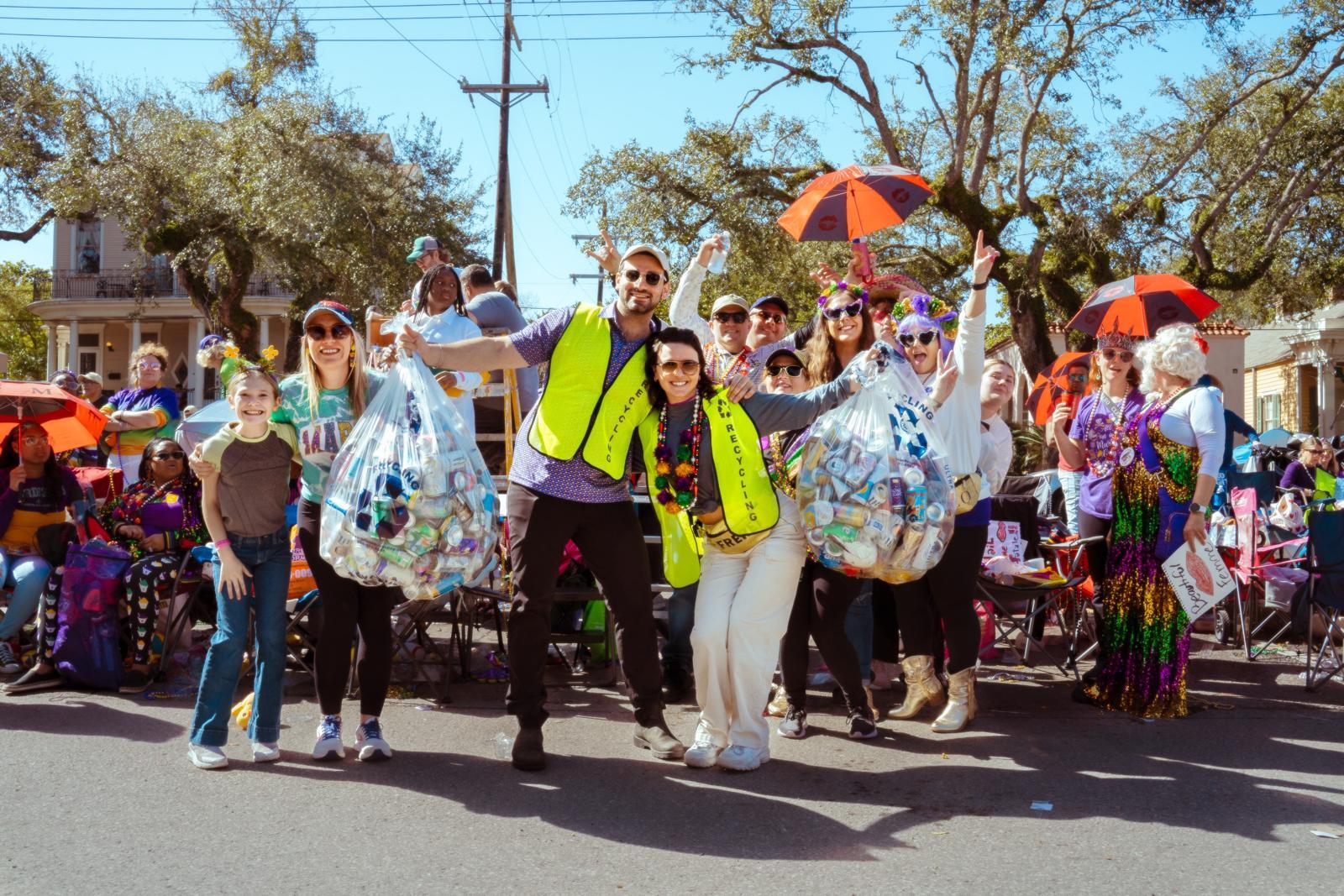 RecycleDAT volunteers holding full recycling bags on the parade route